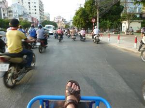 Exploring the busy streets of Saigon in a rickshaw.